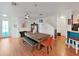 Open dining room featuring a rustic wooden table, bench seating and a cozy ambiance at 31730 Spoonflower Cir, Wesley Chapel, FL 33545