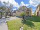 Lovely two-story home with a two-car garage and landscaping on a sunny day at 31730 Spoonflower Cir, Wesley Chapel, FL 33545