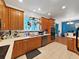 Modern kitchen with wood cabinets, stainless steel appliances, and view of the living space at 31730 Spoonflower Cir, Wesley Chapel, FL 33545