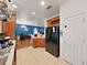 Bright kitchen with oak cabinets, modern appliances, and open layout with connecting dining/office area at 31730 Spoonflower Cir, Wesley Chapel, FL 33545
