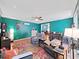 Bright living room features vibrant walls, hardwood floors, and comfortable seating area at 31730 Spoonflower Cir, Wesley Chapel, FL 33545