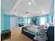 This main bedroom features light blue walls, a large bed, and a cozy nook at 31730 Spoonflower Cir, Wesley Chapel, FL 33545