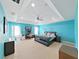 Spacious main bedroom with tray ceiling, fan, and large bed at 31730 Spoonflower Cir, Wesley Chapel, FL 33545