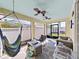 Comfortable covered patio with a ceiling fan, hammock, and outdoor seating at 31730 Spoonflower Cir, Wesley Chapel, FL 33545