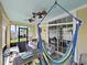 Relaxing covered patio with a hanging chair and outdoor seating area at 31730 Spoonflower Cir, Wesley Chapel, FL 33545