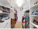 Spacious walk-in closet with ample shelving and hanging space for organized storage at 31730 Spoonflower Cir, Wesley Chapel, FL 33545