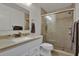 Well-lit bathroom featuring a vanity, toilet, and a glass-enclosed shower with neutral tile at 3268 39Th S St # A, St Petersburg, FL 33711