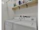 Functional laundry room with a shelf and white washer and dryer units at 3268 39Th S St # A, St Petersburg, FL 33711