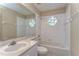 Clean bathroom featuring a tub with shower, octagon-shaped windows, and single sink at 34907 Double Eagle Ct, Zephyrhills, FL 33541