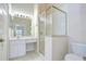 Bright bathroom with a glass-enclosed shower, a vanity with ample counter space, and tile flooring at 34907 Double Eagle Ct, Zephyrhills, FL 33541