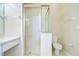 Bright bathroom featuring a glass-enclosed shower, vanity with drawers, and a white toilet at 34907 Double Eagle Ct, Zephyrhills, FL 33541