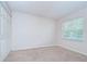 A bright, neutral bedroom features a large window and plenty of closet space at 34907 Double Eagle Ct, Zephyrhills, FL 33541