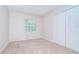 Neutral bedroom featuring a window with blinds and a closet at 34907 Double Eagle Ct, Zephyrhills, FL 33541