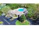 Aerial view of community clubhouse with a kidney shaped pool and ample space to relax at 34907 Double Eagle Ct, Zephyrhills, FL 33541