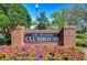 The Lake Bernadette Clubhouse sign is displayed surrounded by landscaping at 34907 Double Eagle Ct, Zephyrhills, FL 33541