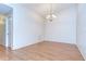 Cozy dining area with hardwood floors, chandelier, and neutral walls at 34907 Double Eagle Ct, Zephyrhills, FL 33541