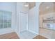 Bright entry foyer with tile flooring transitioning to an open-concept kitchen at 34907 Double Eagle Ct, Zephyrhills, FL 33541