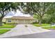 Charming single-story villa with a two-car garage and manicured front lawn at 34907 Double Eagle Ct, Zephyrhills, FL 33541