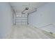 A spacious, single-car garage with an automatic door opener and concrete block walls at 34907 Double Eagle Ct, Zephyrhills, FL 33541