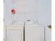A functional laundry room features a washer, a dryer and a convenient wire shelf at 34907 Double Eagle Ct, Zephyrhills, FL 33541