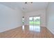 Open living area with sliding glass doors leading to a view of the lawn and golf course at 34907 Double Eagle Ct, Zephyrhills, FL 33541