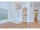Inviting living room featuring vaulted ceilings and hardwood floors with natural light at 34907 Double Eagle Ct, Zephyrhills, FL 33541