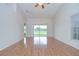 Bright living area features a ceiling fan and slider doors, showcasing the golf course views at 34907 Double Eagle Ct, Zephyrhills, FL 33541