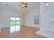 Open-concept living space with vaulted ceilings, fan, and sliding glass doors to the outdoors at 34907 Double Eagle Ct, Zephyrhills, FL 33541