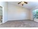 Spacious main bedroom featuring a ceiling fan and large window for natural light at 34907 Double Eagle Ct, Zephyrhills, FL 33541