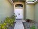 A double-door entryway with an transom window welcomes you into this beautiful home at 35542 Welby Ct, Zephyrhills, FL 33541