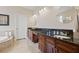 Bathroom featuring double vanity, garden tub, and plentiful storage at 3709 W Horatio St, Tampa, FL 33609