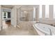 Bright bathroom featuring a glass shower and a large soaking tub at 3709 W Horatio St, Tampa, FL 33609
