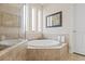 Luxurious bathroom featuring a tub with tile surround and glass enclosed shower at 3709 W Horatio St, Tampa, FL 33609