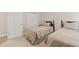 Bedroom with two twin beds, neutral decor, and carpeted floor at 3709 W Horatio St, Tampa, FL 33609