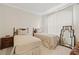 Bedroom with two twin beds, neutral decor, and large window at 3709 W Horatio St, Tampa, FL 33609