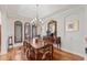 Formal dining room with hardwood floors, decorative mirror, and arched windows at 3709 W Horatio St, Tampa, FL 33609