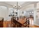 Dining room showcasing hardwood floors, wooden table, and an open view of the living space at 3709 W Horatio St, Tampa, FL 33609