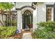 Elegant entryway featuring an arched column, security system, and a well-manicured landscape at 3709 W Horatio St, Tampa, FL 33609