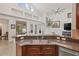 Kitchen with granite countertops, wooden cabinets, and open view to the living room and dining area at 3709 W Horatio St, Tampa, FL 33609
