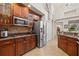 Kitchen boasts stainless steel appliances, wooden cabinets, and a view to the open floor plan at 3709 W Horatio St, Tampa, FL 33609