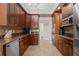 Well-equipped kitchen featuring wooden cabinets, granite countertops, and stainless steel appliances at 3709 W Horatio St, Tampa, FL 33609