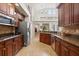 Kitchen displaying wooden cabinets, modern appliances, and open access to the dining area at 3709 W Horatio St, Tampa, FL 33609
