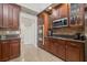 Kitchen showcasing wooden cabinets, stainless steel appliances, and stylish backsplash at 3709 W Horatio St, Tampa, FL 33609