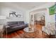 Bright living room featuring hardwood floors, comfortable sofa, and open view to dining area at 3709 W Horatio St, Tampa, FL 33609