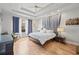 Luxurious main bedroom featuring a tray ceiling, hardwood floors, and an abundance of light at 3709 W Horatio St, Tampa, FL 33609