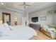 Comfortable main bedroom showcasing hardwood floors, ceiling fan and doorway to ensuite bathroom at 3709 W Horatio St, Tampa, FL 33609