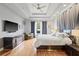 Relaxing main bedroom showcasing hardwood floors, ceiling fan and window view at 3709 W Horatio St, Tampa, FL 33609