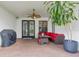 Inviting covered patio with brick floors, fan, grill and comfortable seating, perfect for outdoor relaxation at 3709 W Horatio St, Tampa, FL 33609
