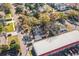 An aerial view of a home featuring a unique roof and mature trees near a commercial area at 3710 W Griflow St, Tampa, FL 33629