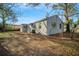 Exterior view of backyard and the back of the house with mature trees at 3710 W Griflow St, Tampa, FL 33629